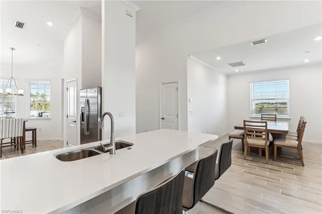a kitchen with kitchen island a sink table and chairs