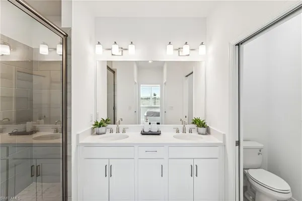 a bathroom with a sink double vanity and a mirror