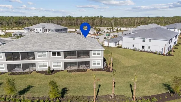 aerial view of a house with a yard