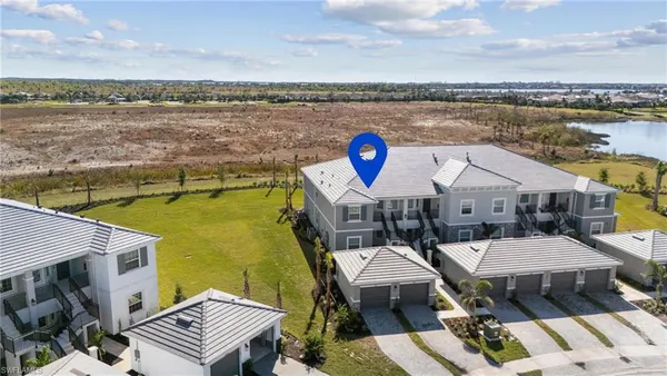 a view of a balcony with wooden floor and outdoor seating