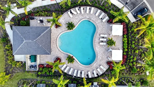an aerial view of a house with swimming pool and outdoor seating
