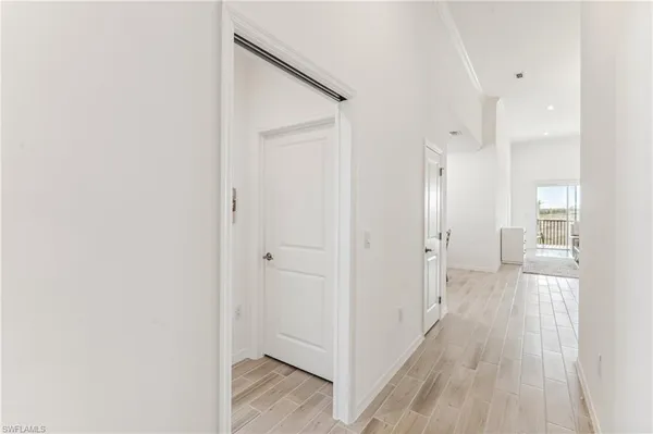 a view of a hallway with wooden floor