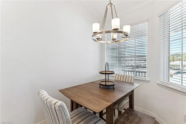 a view of a dining room with a table and chairs