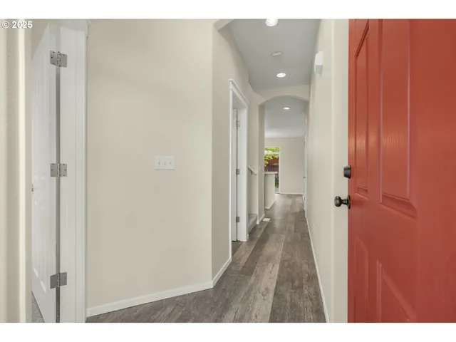 a view of a hallway with wooden floor
