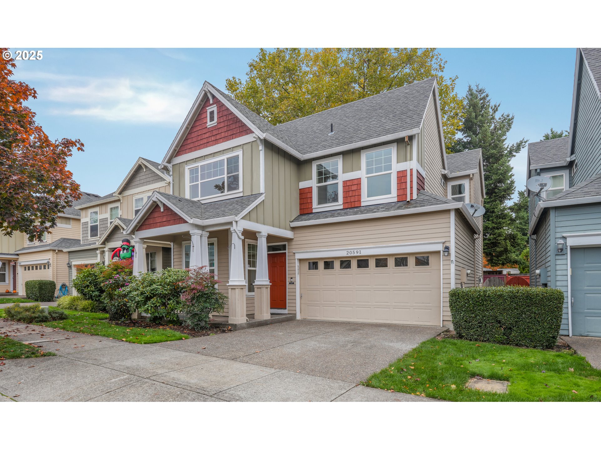 20591 Southwest Ravenswood Street Beaverton, OR 97078 - Photo 31 of 31 a front view of a house with a yard and garage