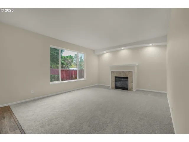 a view of empty room with a fireplace