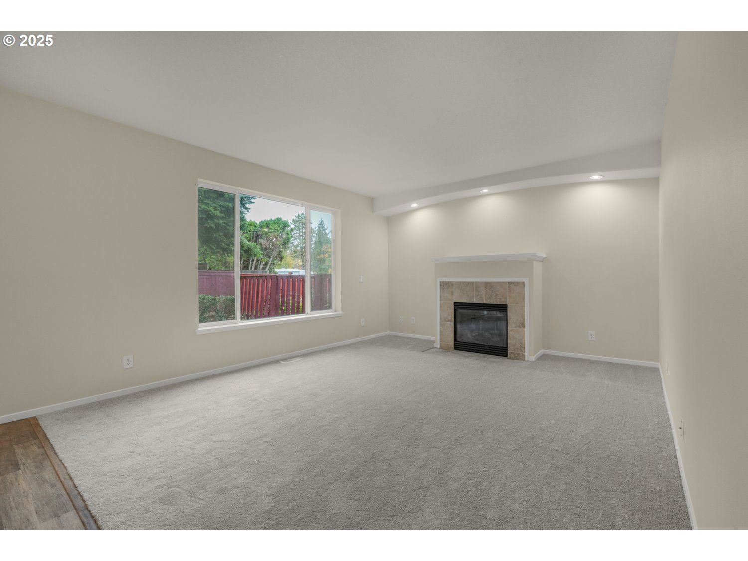 20591 Southwest Ravenswood Street Beaverton, OR 97078 - Photo 5 of 31 a view of empty room with a fireplace