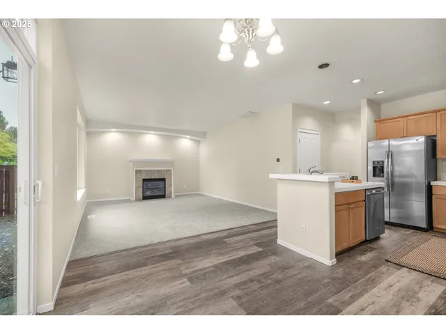 a view of kitchen with cabinets and refrigerator
