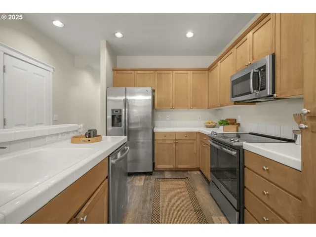 a kitchen with a sink a stove a refrigerator and cabinets