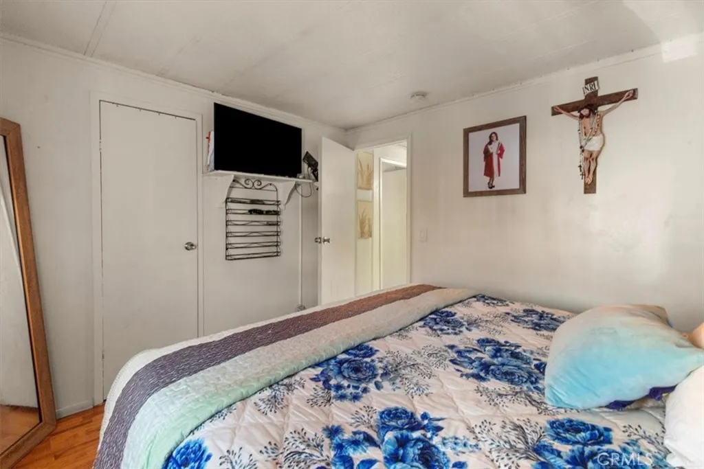 9080 Bloomfield Avenue, Unit 33 Cypress, CA 90630 - Photo 19 of 30 a bedroom with a bed and a flat screen tv
