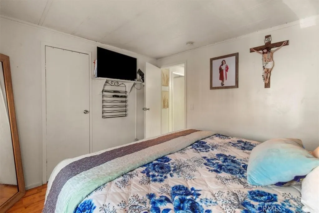9080 Bloomfield Avenue, Unit 33 Cypress, CA 90630 - Photo 19 of 30 a bedroom with a bed and a flat screen tv