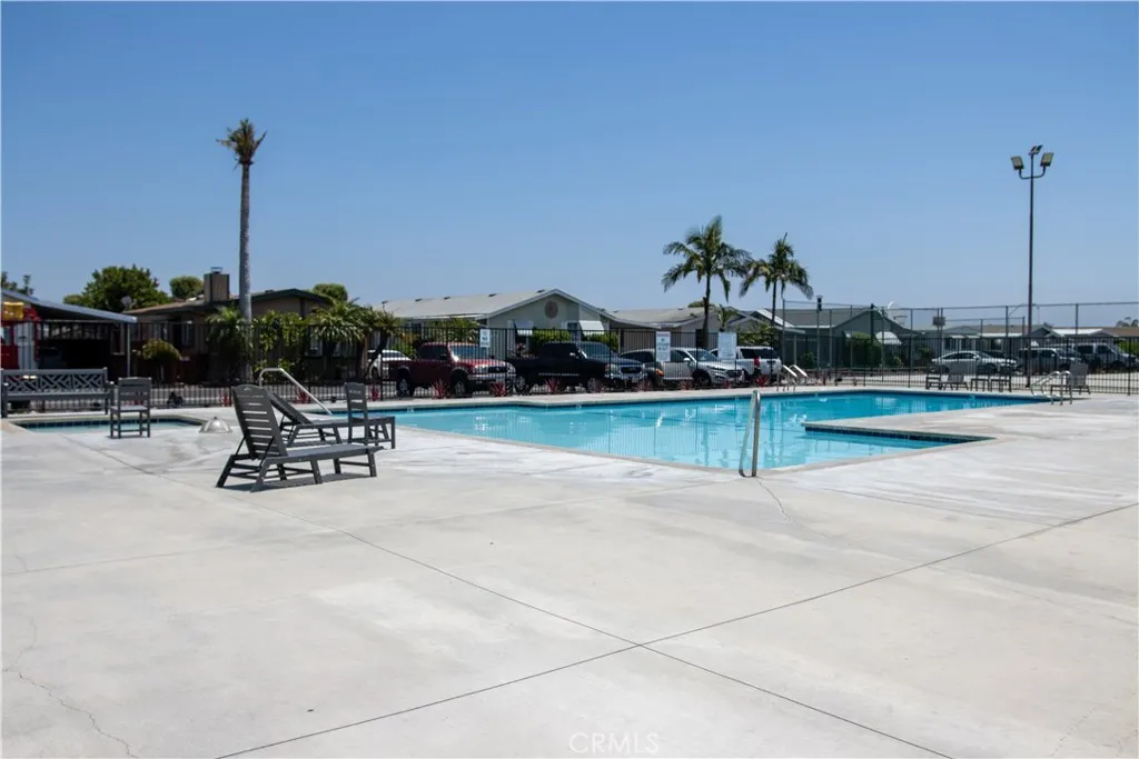 9080 Bloomfield Avenue, Unit 33 Cypress, CA 90630 - Photo 29 of 30 a view of a swimming pool with a table and chairs