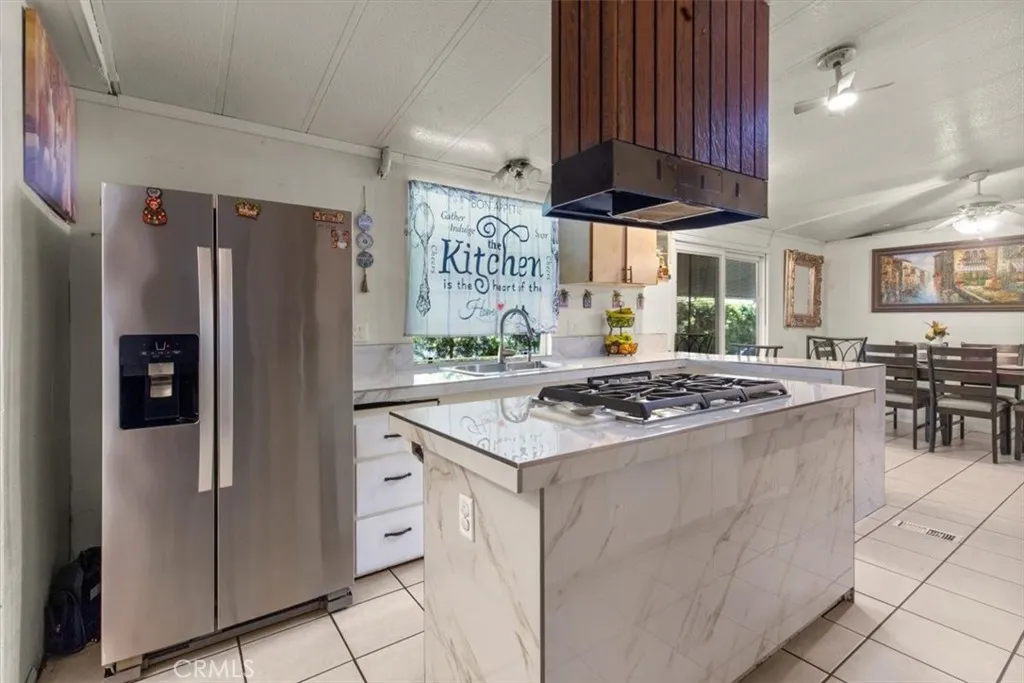 9080 Bloomfield Avenue, Unit 33 Cypress, CA 90630 - Photo 5 of 30 The kitchen boasts a spacious layout with updated finishes, abundant natural light, and plenty of room for cooking, dining, and entertaining.