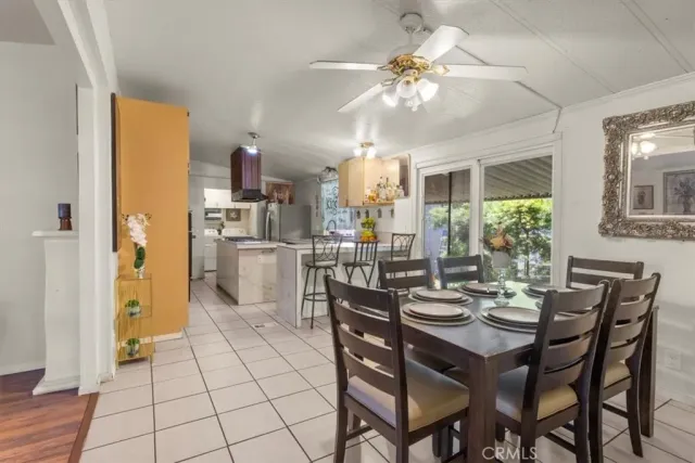 a view of a dining room and kitchen with a table chairs