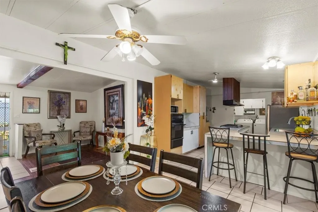 9080 Bloomfield Avenue, Unit 33 Cypress, CA 90630 - Photo 10 of 30 a kitchen with a table and chairs