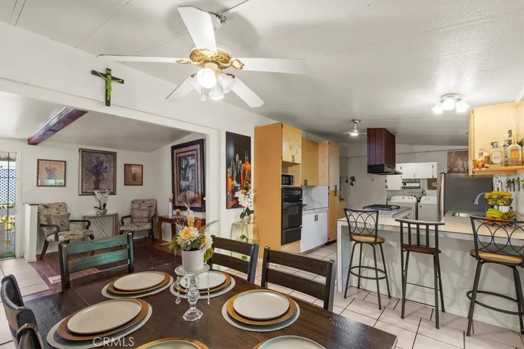 9080 Bloomfield Avenue, Unit 33 Cypress, CA 90630 - Photo 10 of 30 The dining and living room offer an open, inviting layout with abundant natural light, perfect for gatherings and everyday comfort.