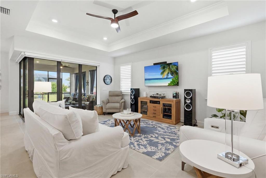 18364 Ridgeline Drive Estero, FL 33928 - Photo 10 of 50 a living room with furniture a fireplace and a flat screen tv