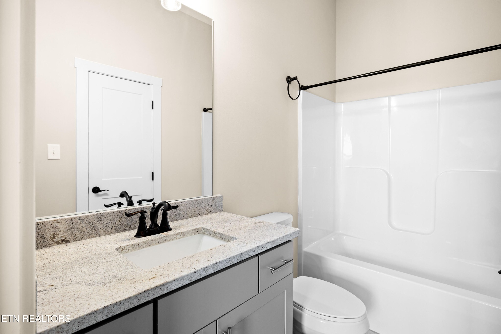 7791 Morganton Road Greenback, TN 37742 - Photo 37 of 53 a bathroom with a granite countertop sink a toilet and shower