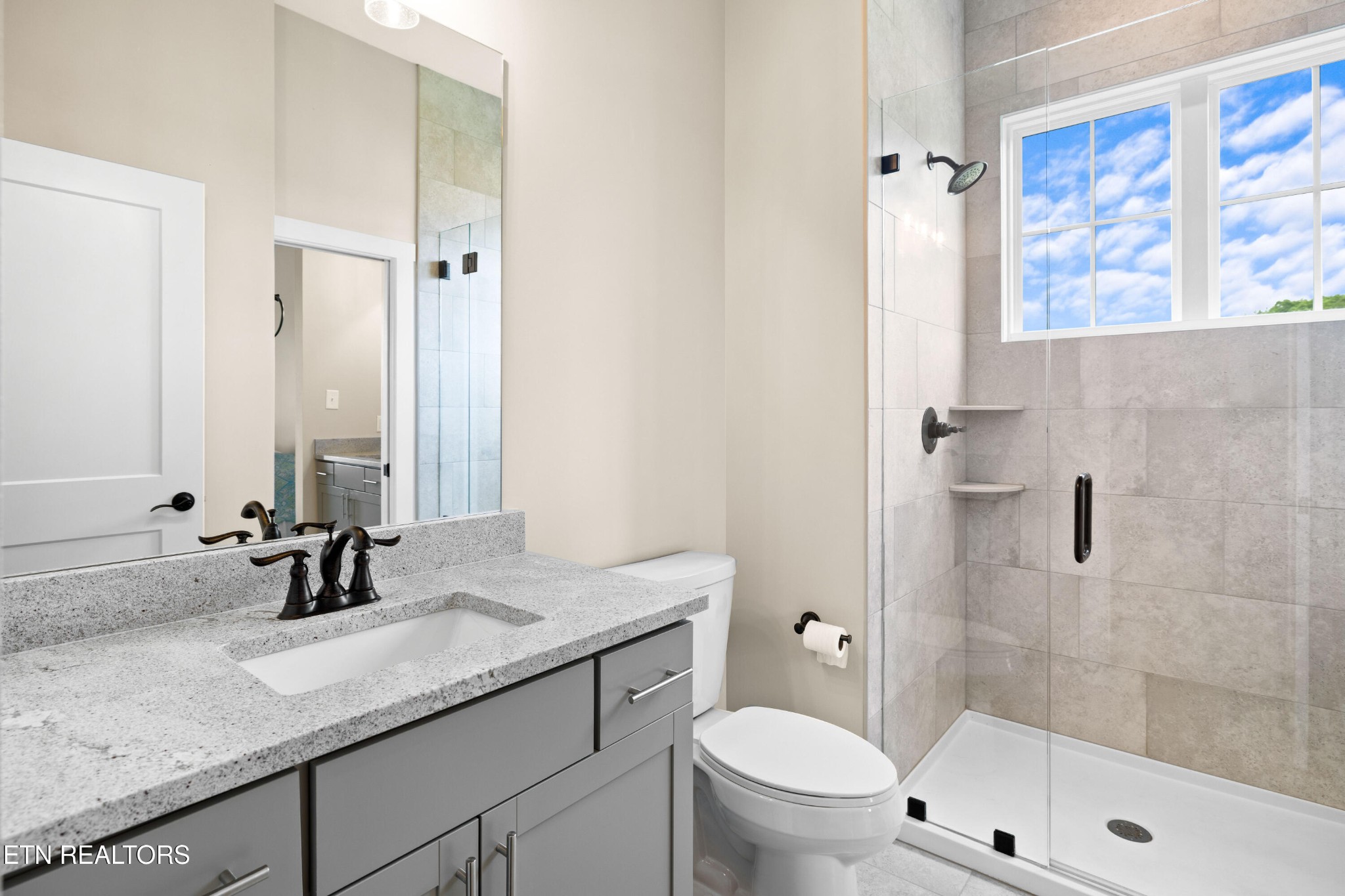7791 Morganton Road Greenback, TN 37742 - Photo 40 of 53 a bathroom with a granite countertop sink a toilet and shower
