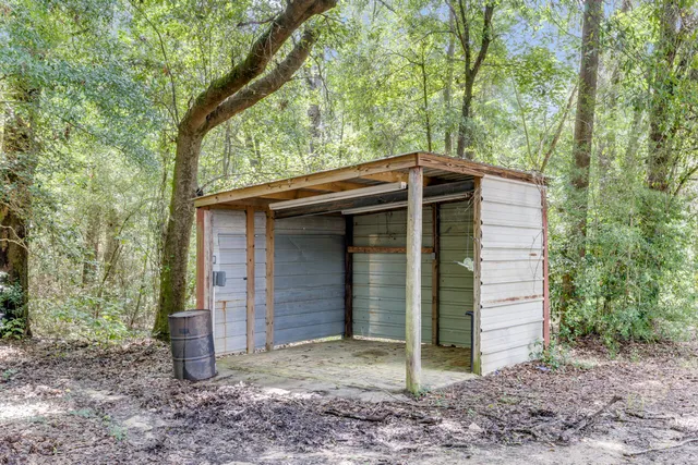 a view of house with a backyard