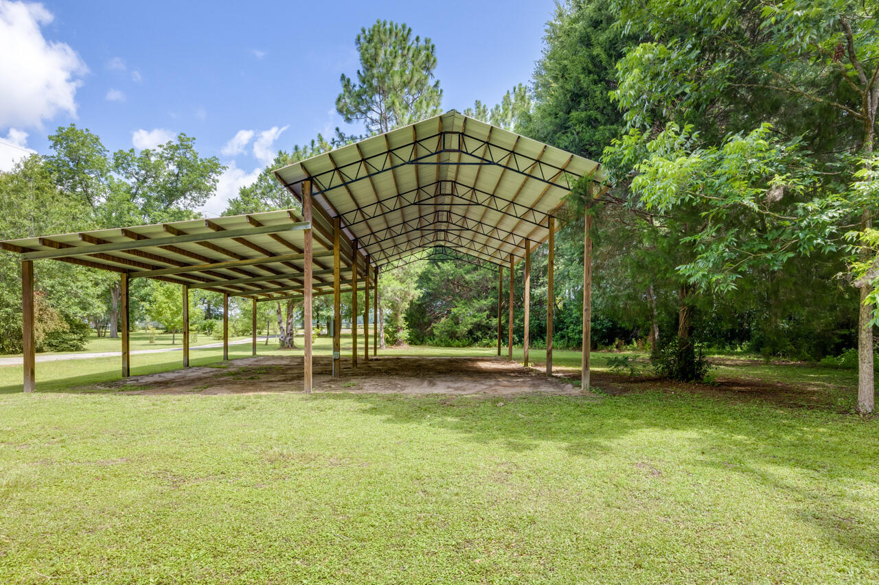 1318 John Riley Barnhill Road Baker, FL 32531 - Photo 16 of 40 a view of yard with swimming pool and trees in the background
