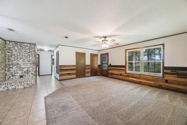 a view of a livingroom with furniture hardwood floor and a ceiling fan