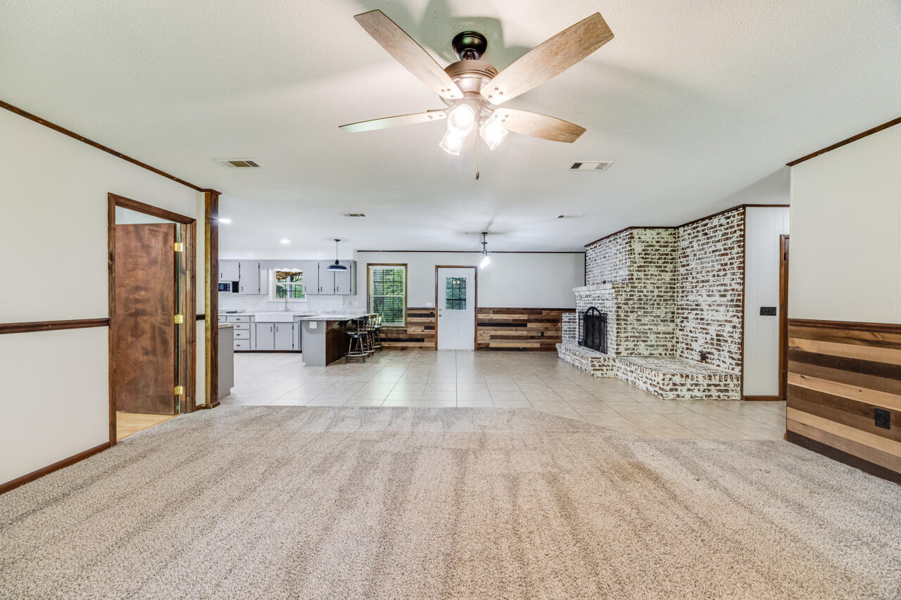 1318 John Riley Barnhill Road Baker, FL 32531 - Photo 20 of 40 a view of a livingroom with furniture hardwood floor and a ceiling fan
