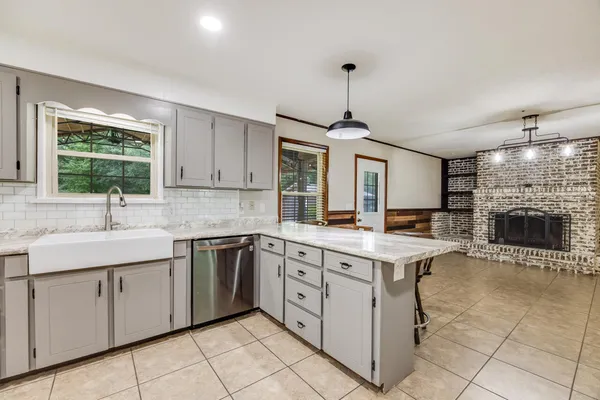 a kitchen with a sink stove top oven and cabinets