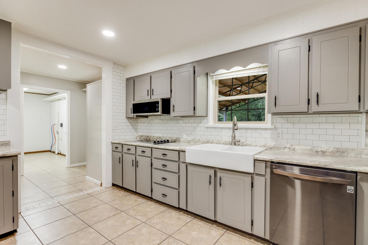 1318 John Riley Barnhill Road Baker, FL 32531 - Photo 24 of 40 a kitchen with a sink stove top oven and cabinets