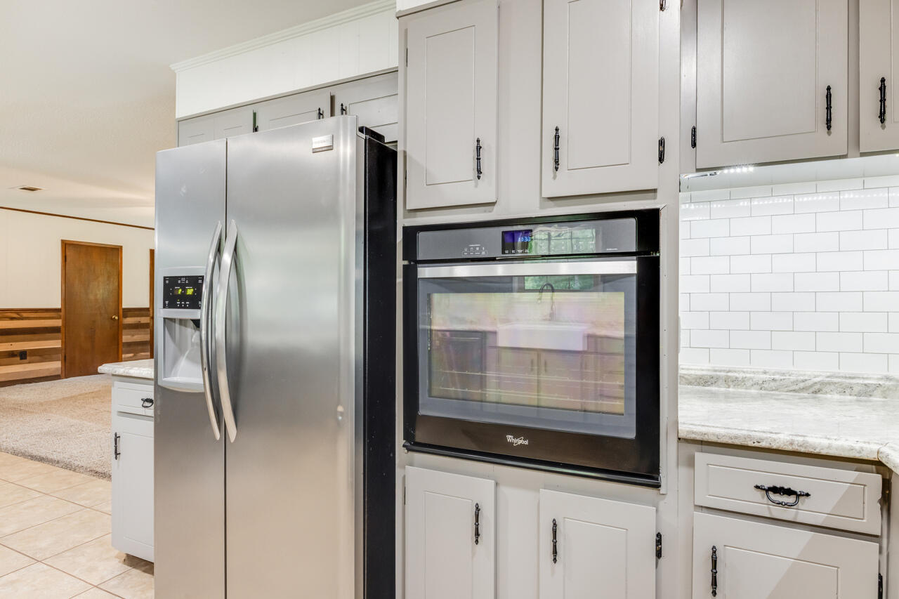 1318 John Riley Barnhill Road Baker, FL 32531 - Photo 26 of 40 a kitchen with metallic refrigerator freezer and a dishwasher