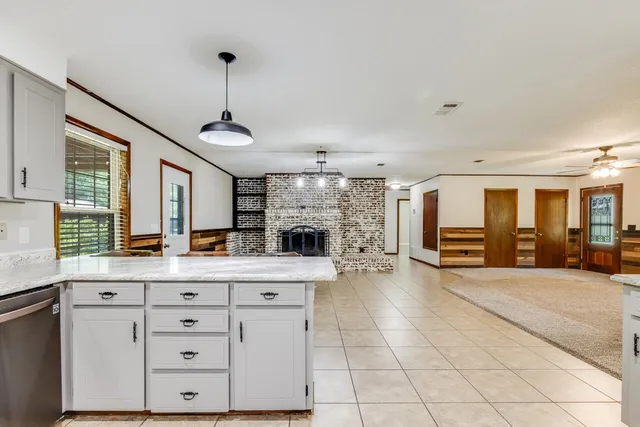 an empty room with windows and mirror