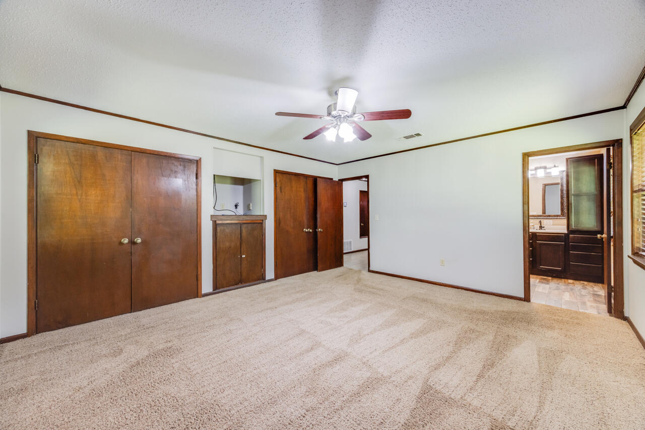 1318 John Riley Barnhill Road Baker, FL 32531 - Photo 29 of 40 a view of a big room with closet and a chandelier fan