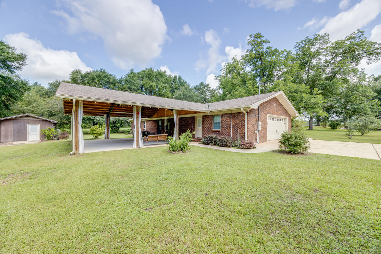 1318 John Riley Barnhill Road Baker, FL 32531 - Photo 3 of 40 a view of a house with backyard and garden
