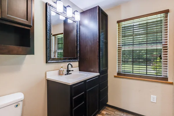 a bath tub sitting next to a white sink and a shower