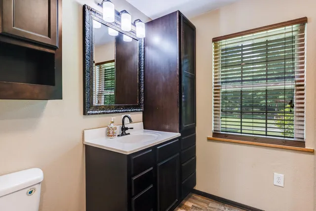 a bath tub sitting next to a white sink and a shower