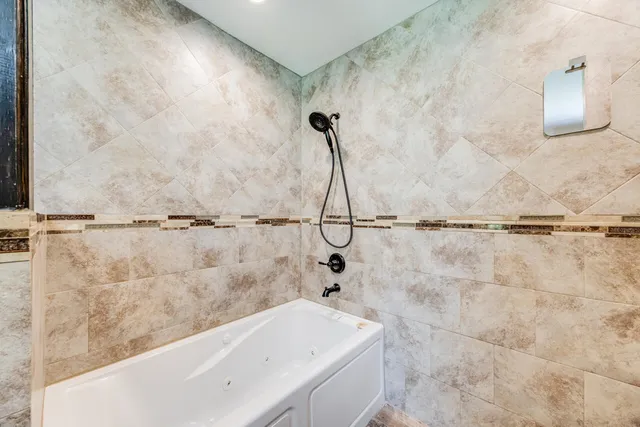 an empty room with window and ceiling fan