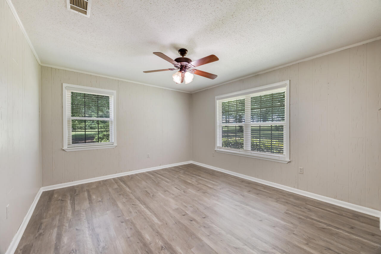 1318 John Riley Barnhill Road Baker, FL 32531 - Photo 35 of 40 a view of an empty room with a window and a chandelier fan