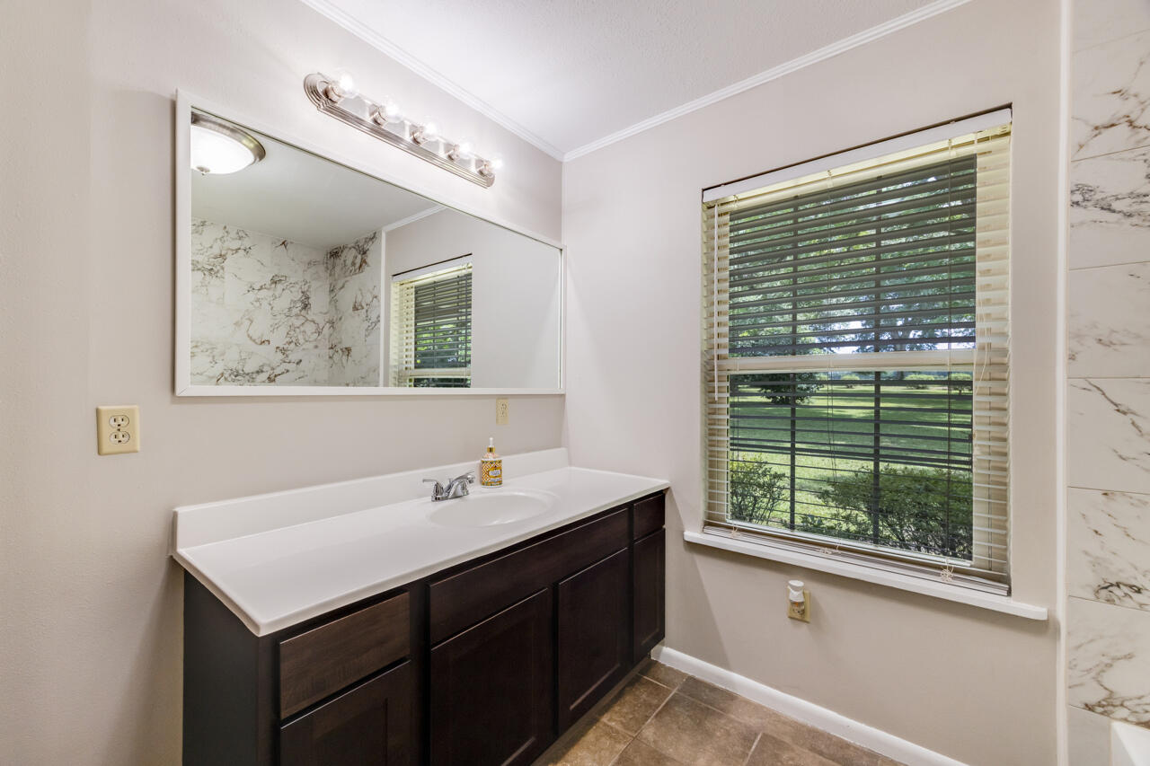 1318 John Riley Barnhill Road Baker, FL 32531 - Photo 36 of 40 a bathroom with a sink and a mirror