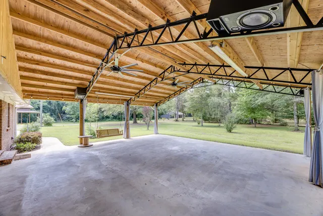 a view of a house with a patio and a yard