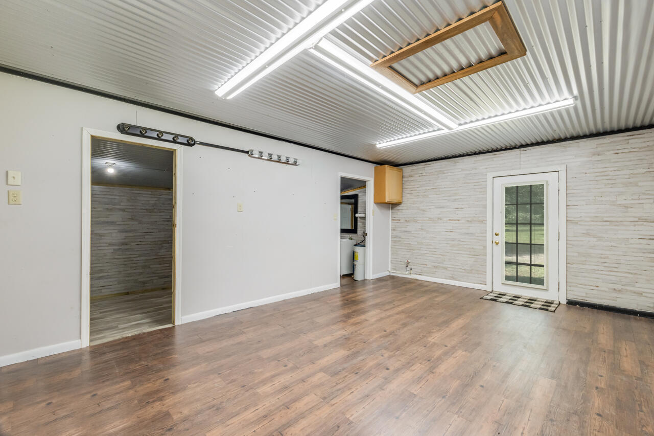 1318 John Riley Barnhill Road Baker, FL 32531 - Photo 8 of 40 an empty room with wooden floor and windows