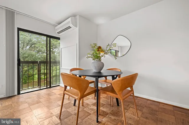 a kitchen with a table chairs and cabinets