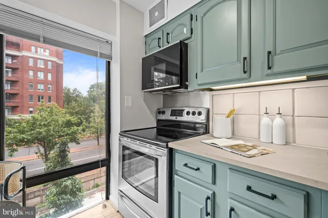 a kitchen with stainless steel appliances granite countertop a sink and cabinets
