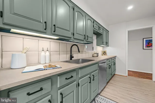 a kitchen with stainless steel appliances granite countertop a sink and cabinets
