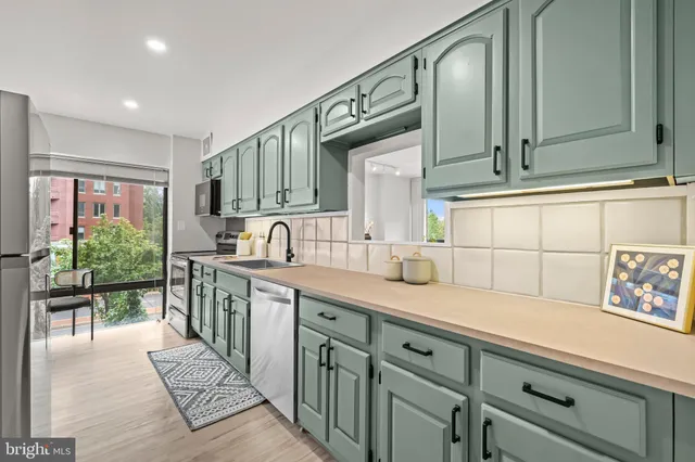 a dining room with furniture and a potted plant