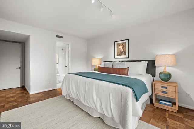 a bedroom with a bed and a mirror