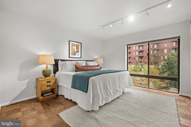 a bedroom with a bed and a large window