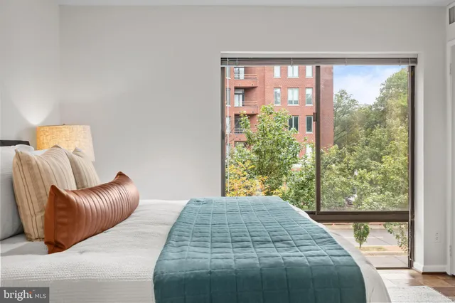 a bedroom with a large bed and a large window