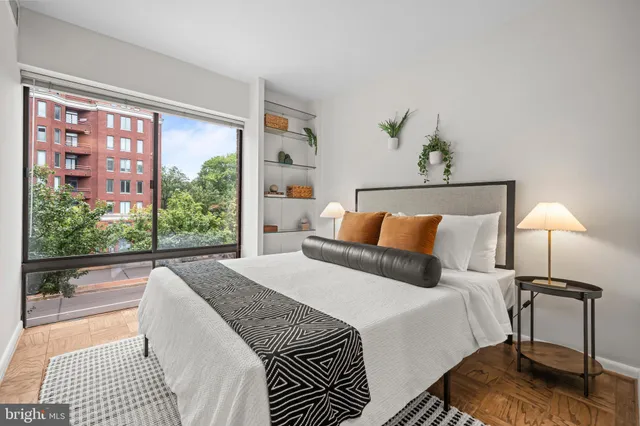 a bedroom with a bed and a lamp