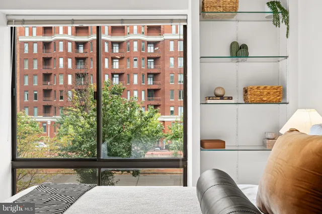 a bedroom with a bed and a large window