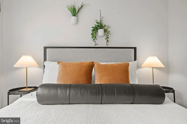 a bedroom with a bed and a lamp